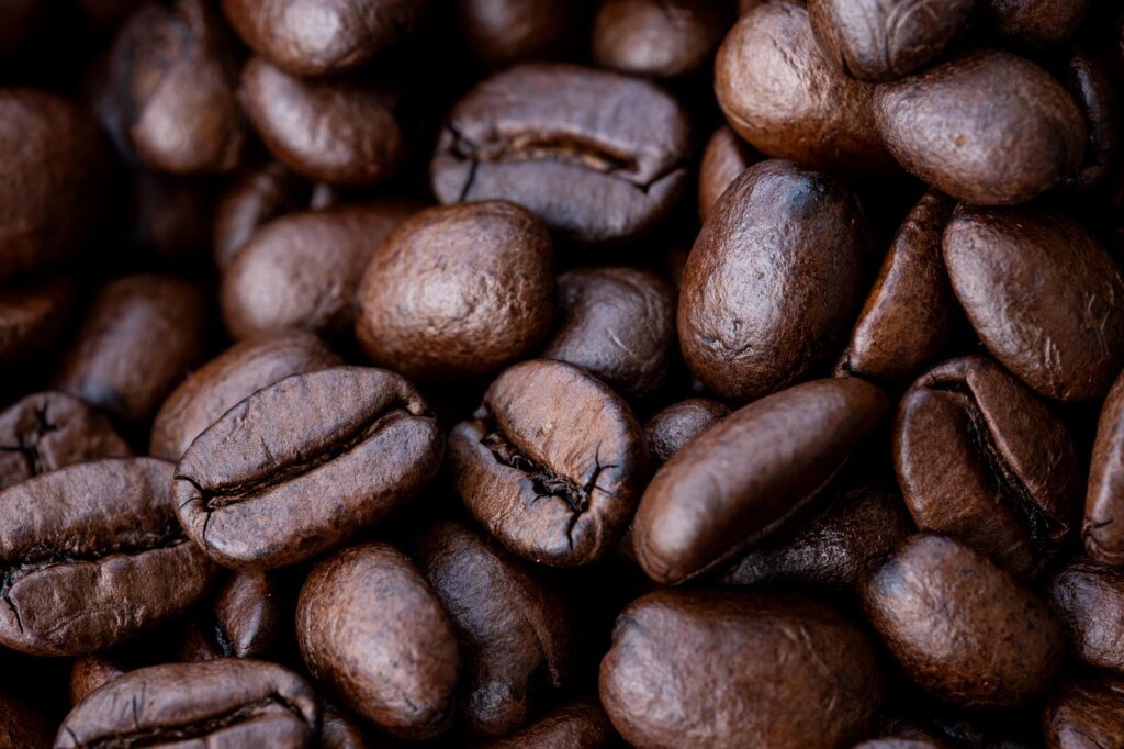 Close-up view of roasted coffee beans showcasing their rich texture and deep brown color.